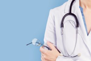 doctor holds a pair of glasses