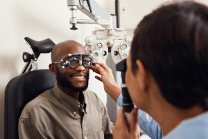 Shot of an young man getting new glasses fitted by an optometrist